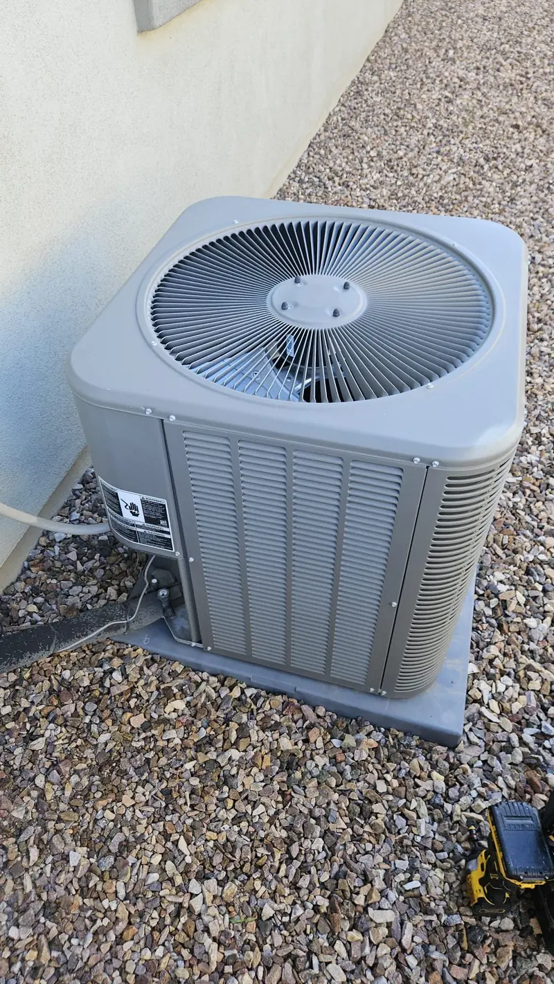 Outdoor AC condenser installation at an Arizona home