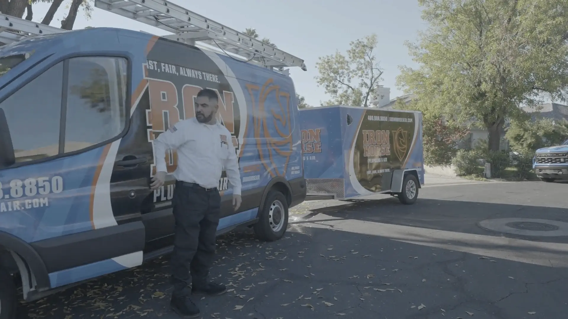 Iron Horse service van and trailer on a neighborhood job